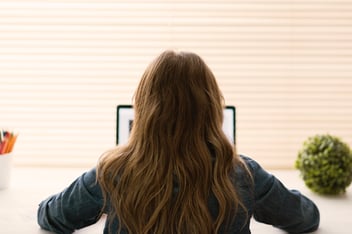 Woman facing her laptop