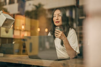 Woman working at laptop at coffee shop