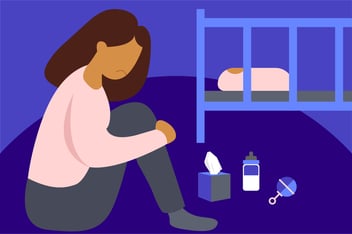 Woman sitting by a crib